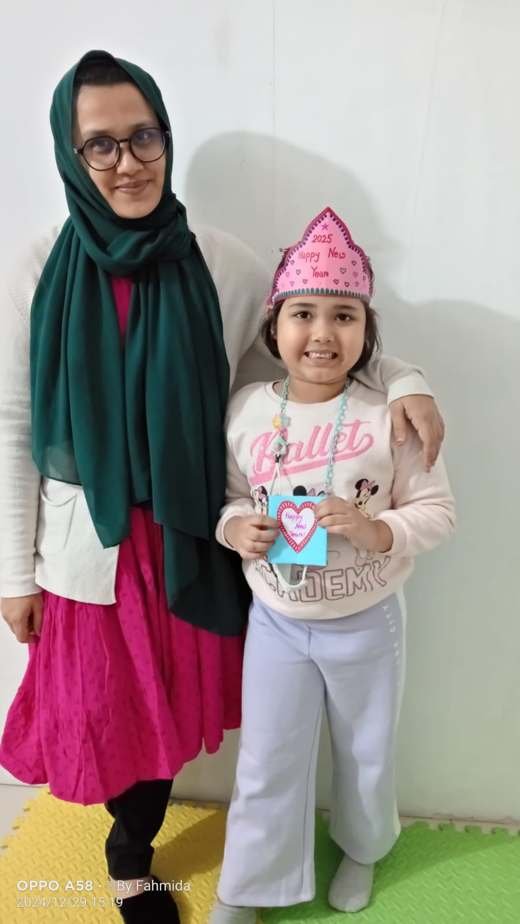 A therapist and child with a New Year crown and card