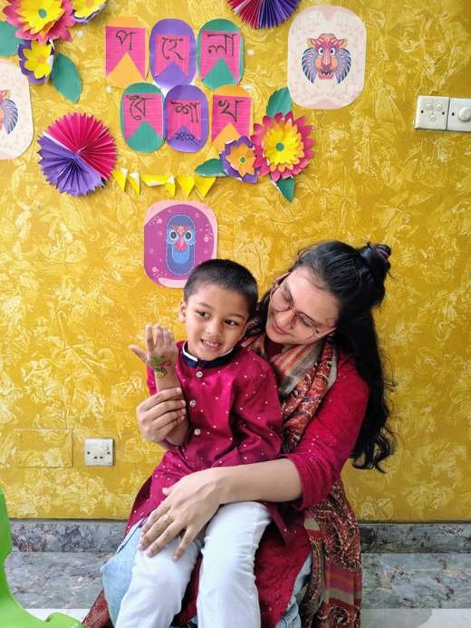 A therapist and child at a Pohela Boishakh decoration
